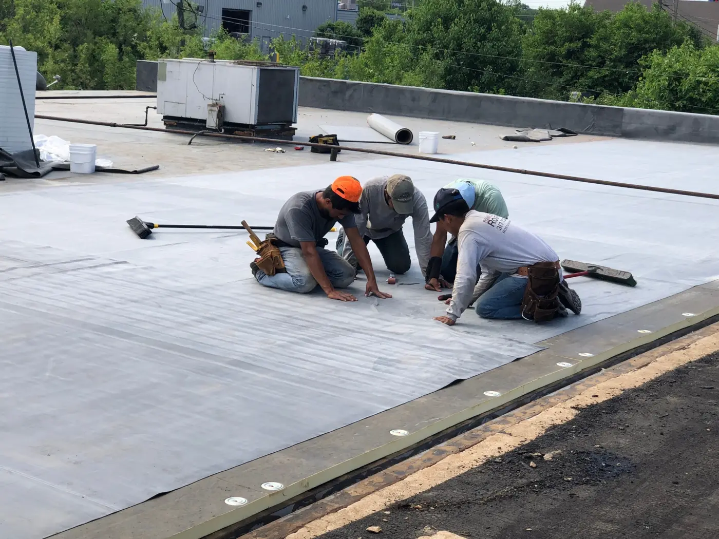 Crew sealing a flat roof